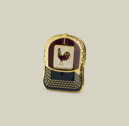The Goorin Bros. Rooster Trucker Pin in Desire Red features a bold rooster emblem and is displayed on a plain beige background.
