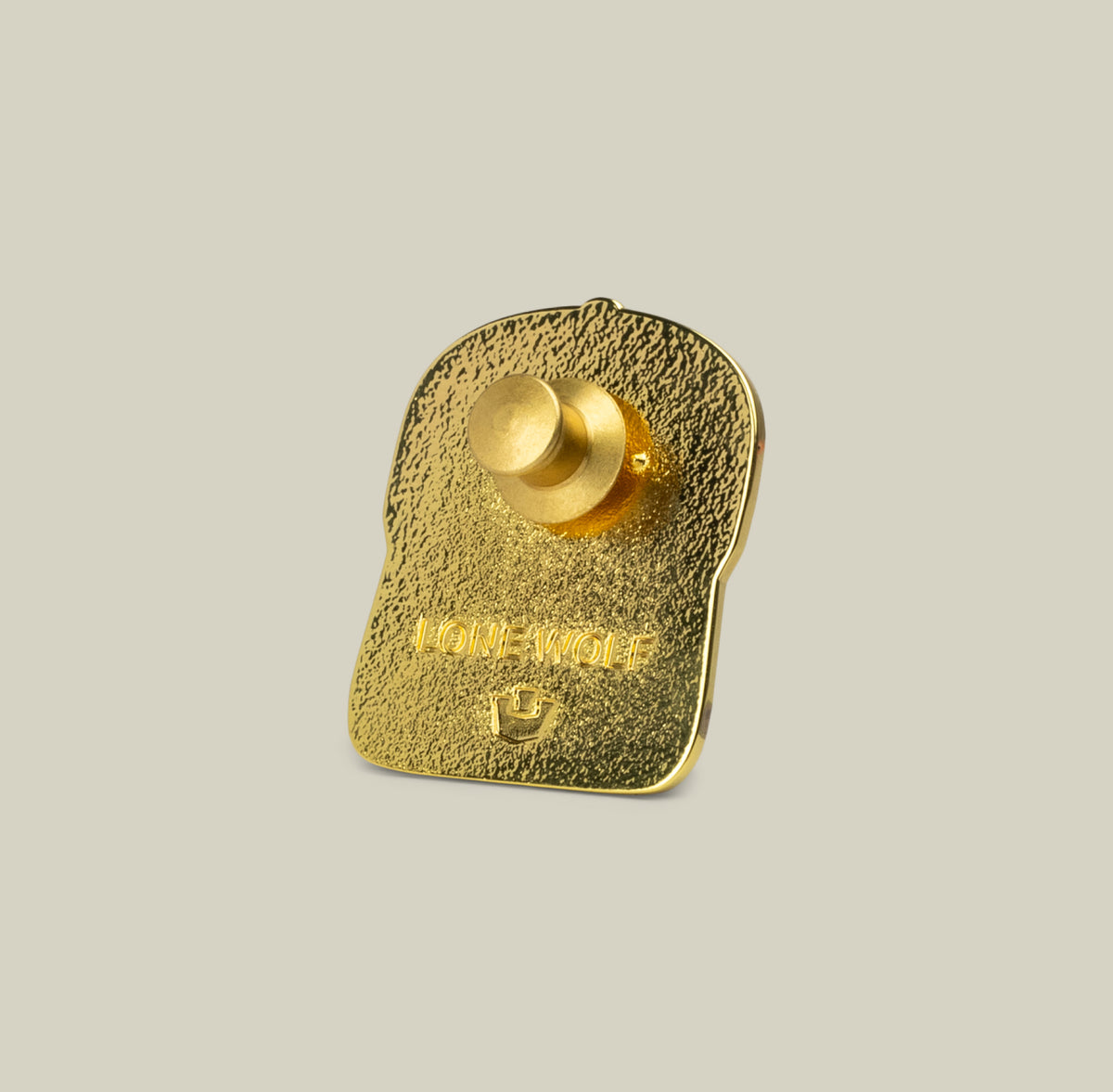 Show your wolf energy on the road with the gold-colored Lone Wolf Trucker Pin by Goorin Bros., featuring a textured surface, butterfly clutch, and engraved “LONE WOLF.”.
