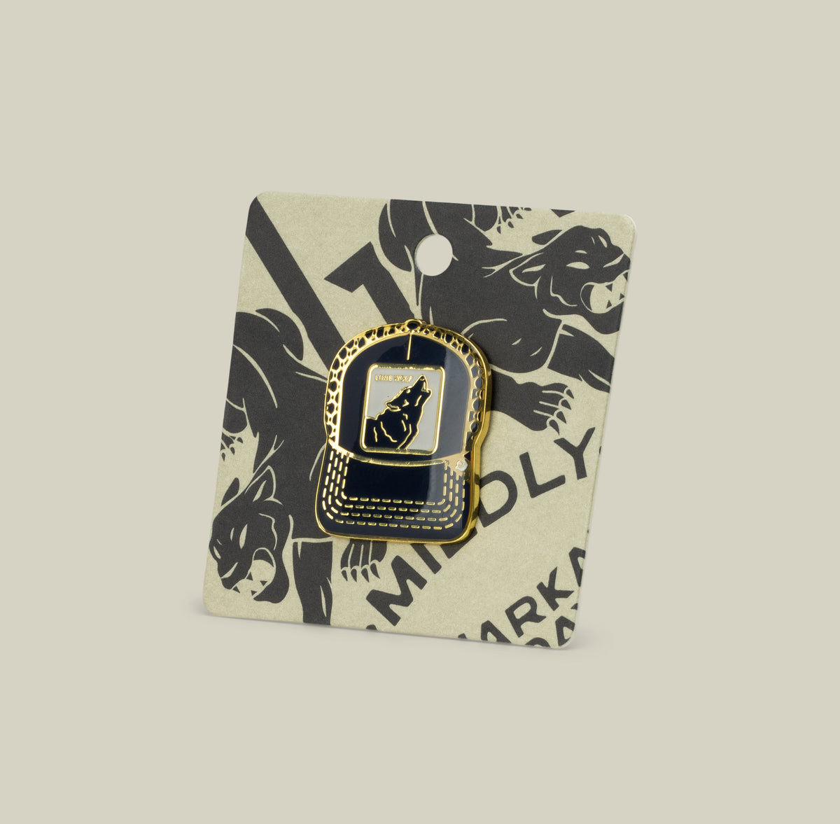 Show off your wolf energy with the gold and black enamel Lone Wolf Trucker Pin by Goorin Bros., featuring a howling wolf on a card with black illustrated wolves.