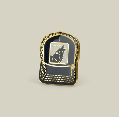 The Goorin Bros. Lone Wolf Trucker Pin in Pennant features a trucker hat shape with a howling wolf and “Lone Wolf” above it.