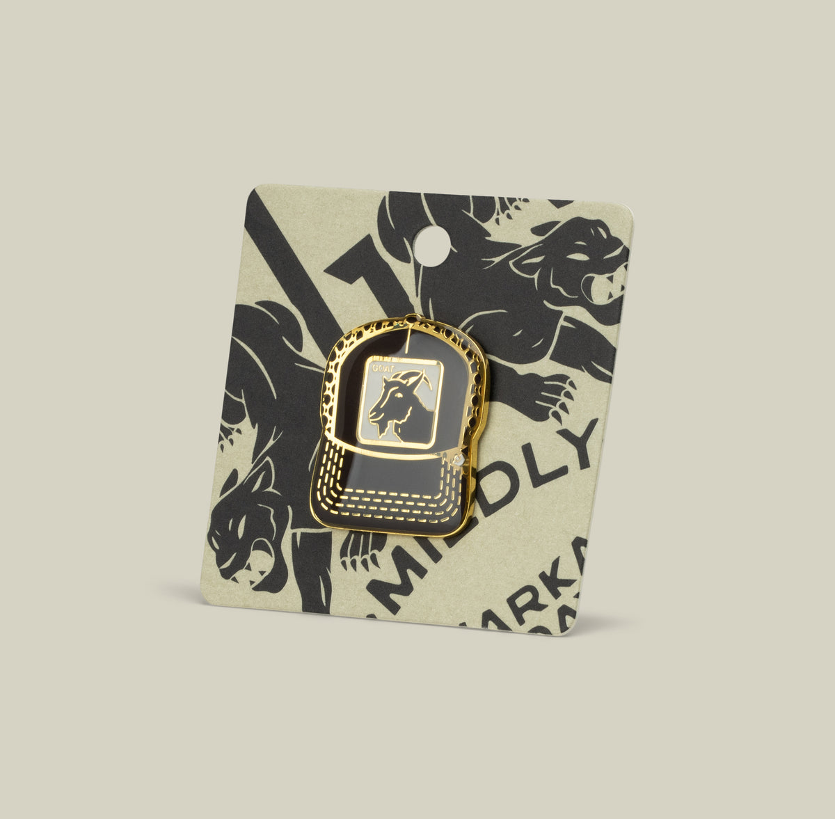 The Goat Trucker Pin by Goorin Bros. is a gold zinc alloy hat-shaped pin with a dog logo, displayed on a backing card featuring black dog illustrations.