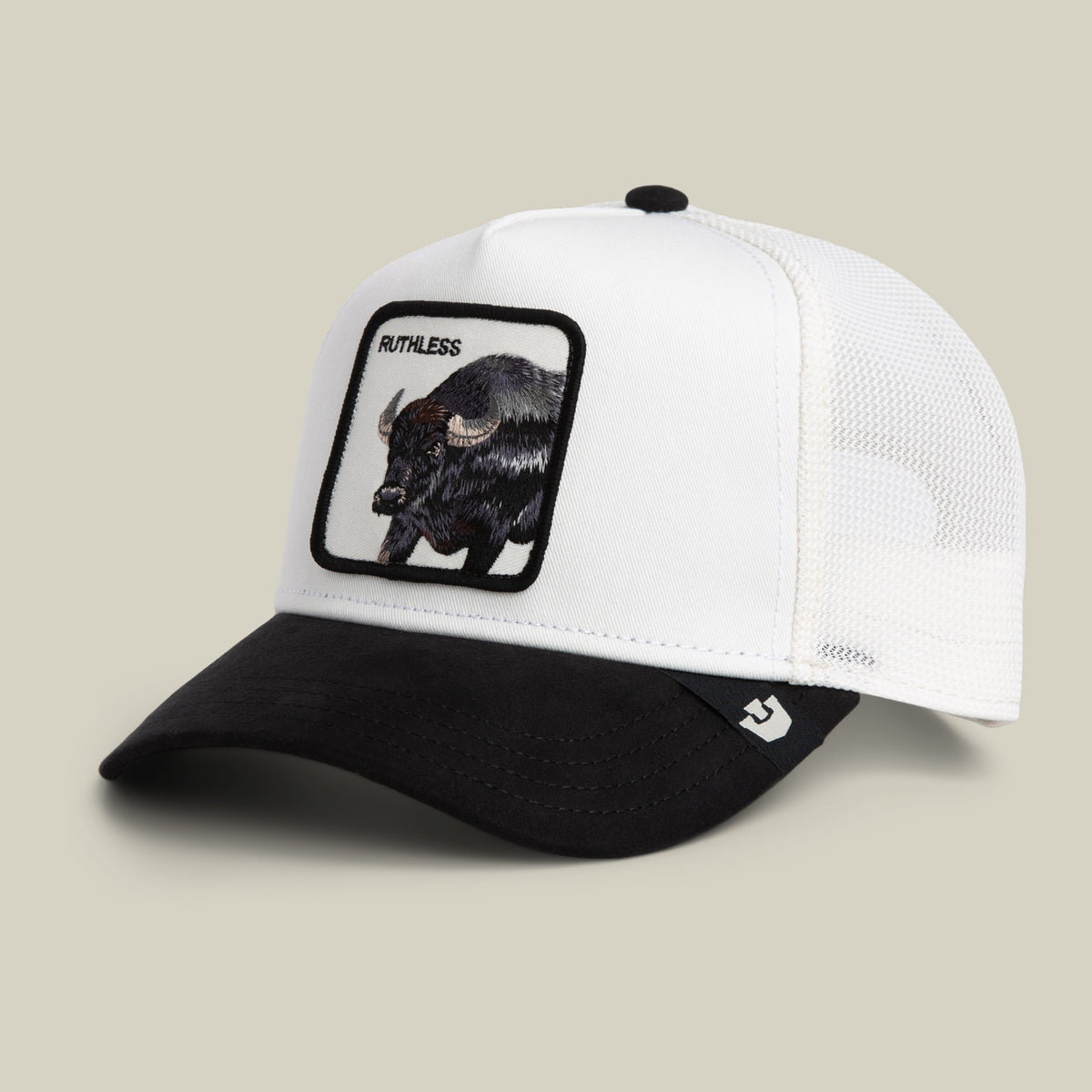 The Suede Ruthless by Goorin Bros. is a black and white mesh trucker hat with a black bill, highlighted by an embroidered buffalo head patch and the word “RUTHLESS” on the front—bringing a bold twist to the classic buffalo trucker style.