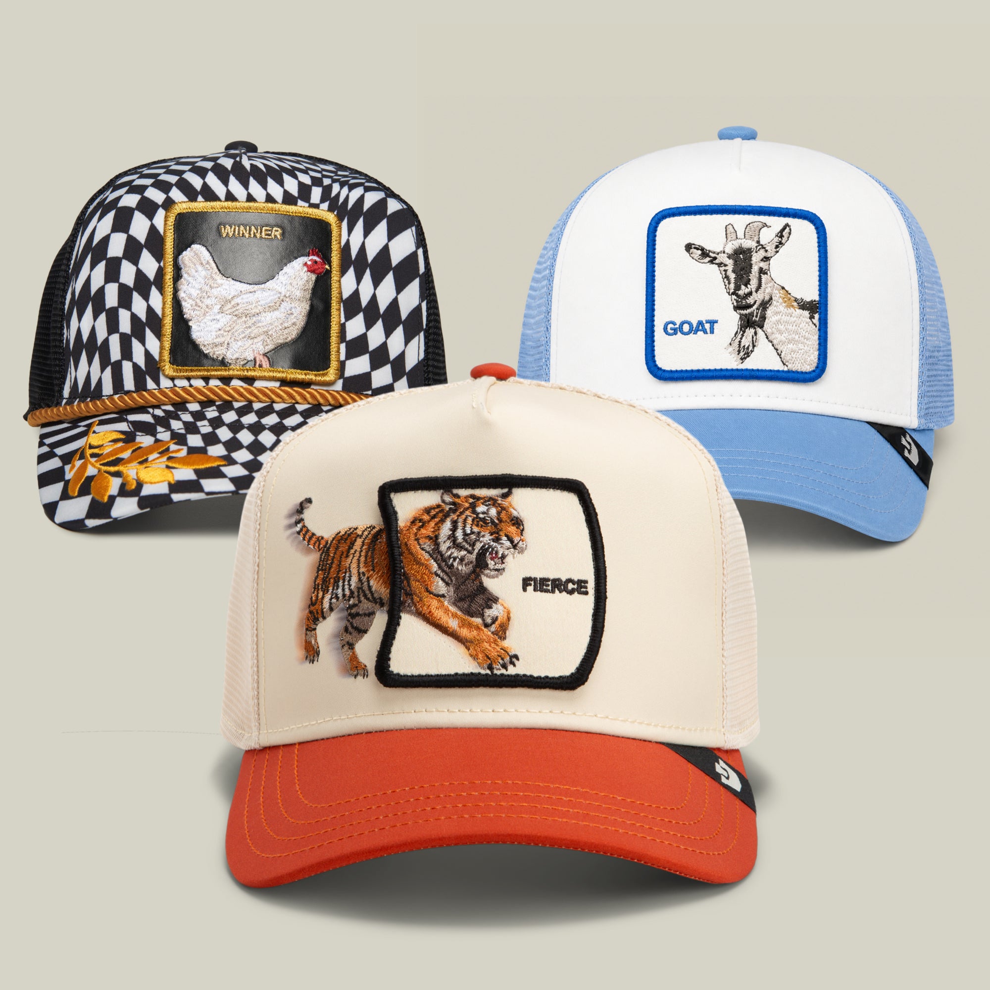 The Goorin Bros. 1st Place Bundle features three trucker hats, each with a unique animal patch: a bold “Winner” chicken cap, a “Goat” patch hat labeled GOAT, and a tiger cap proudly emblazoned with “Fierce”—all in distinct colors.