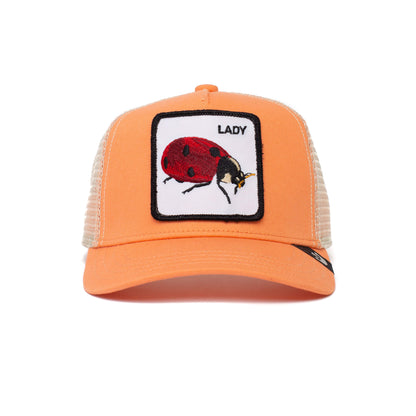 The Farm's "Little Lady" is an orange mesh adjustable trucker hat for kids ages 4-10, featuring a front patch with an embroidered red ladybug and the word LADY above it.