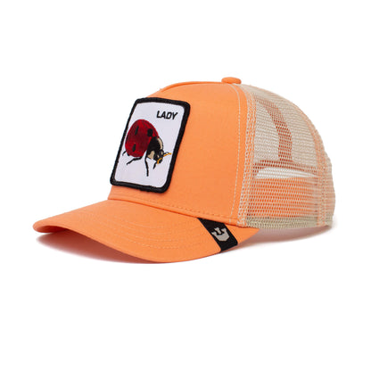 The Farm's Little Lady is a kid-sized orange mesh trucker hat with a curved bill, beige mesh back, and a front patch featuring a ladybug and "LADY." Designed for ages 4-10, it offers adjustable comfort.