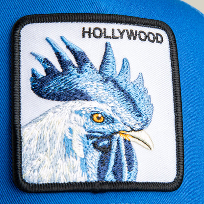 A close-up of the Goorin Bros. Hollywood Rooster Mini patch, kid size, embroidered in blue and white with "HOLLYWOOD" lettering on an electric blue mesh background.