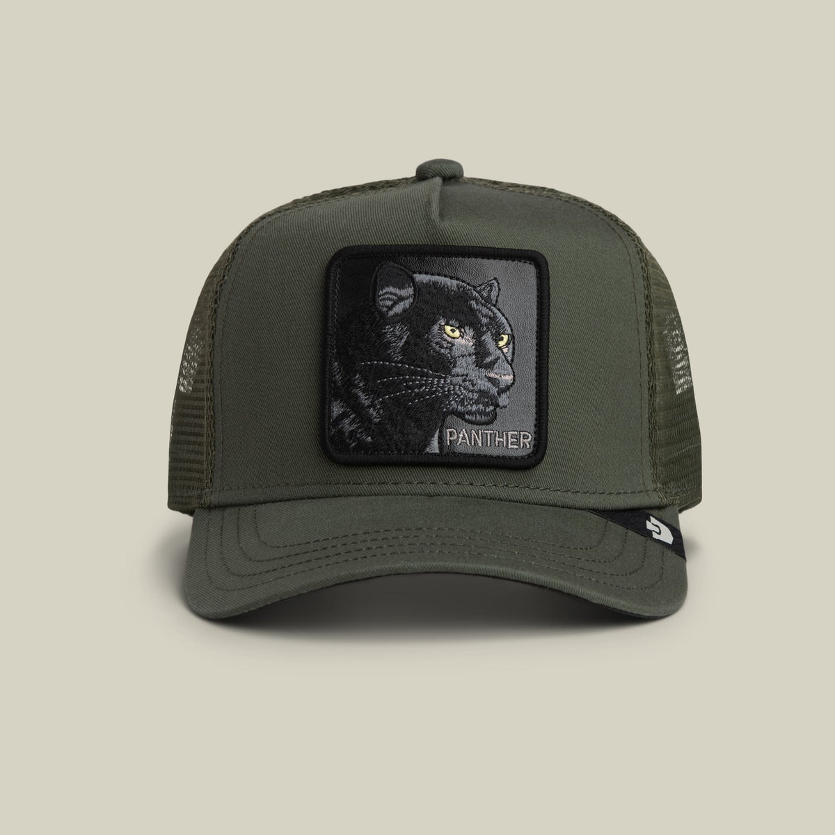 The Goorin Bros. Panther Trucker Mini is an olive green mesh snapback cap featuring an embroidered black panther patch with golden eyes on the front and the word Panther text below, shown against a neutral studio background.