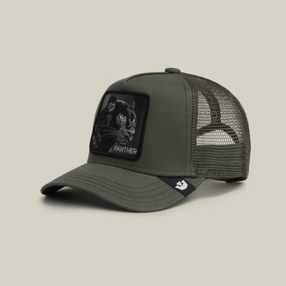 The Goorin Bros. Panther Trucker Mini is an olive green mesh trucker hat featuring a black embroidered panther patch with yellow eyes on the front panel and a small brand logo on the chin strap, displayed against a neutral background.