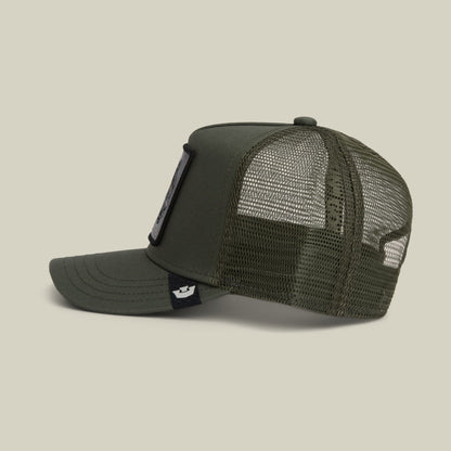 The Goorin Bros. Panther Trucker Mini is an olive green mesh trucker cap with a solid front panel, adjustable snapback closure, and a small branded patch on the side strap, shown in a studio product shot.