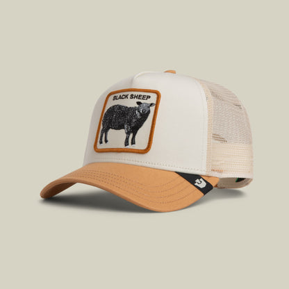 The Goorin Bros. Black Sheep Trucker Mini features a white front panel and tan mesh back with an embroidered black sheep patch trimmed in orange, displayed on a neutral background.