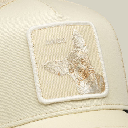 The Goorin Bros. Tonal Amigo Mini is a cream trucker hat featuring an embroidered patch with a tan and white llama design and Goorin branding on the front panel.