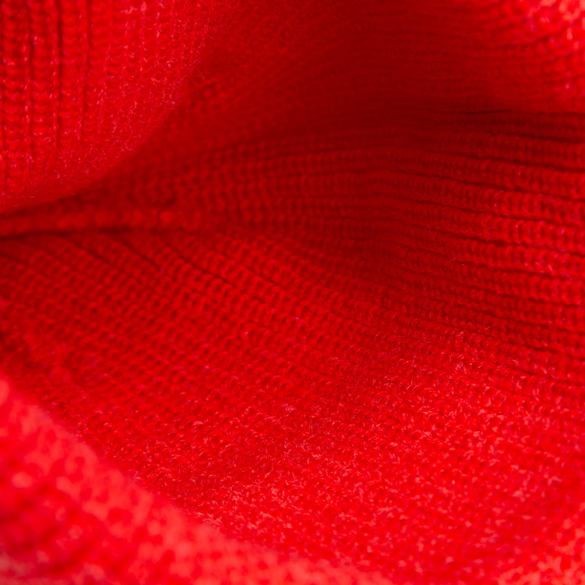 Close-up of The Wild Beanie Mini by Goorin Bros.—a vibrant red knit with detailed texture and stitching, ideal for kids’ wear or adding a playful touch to your bright creations.