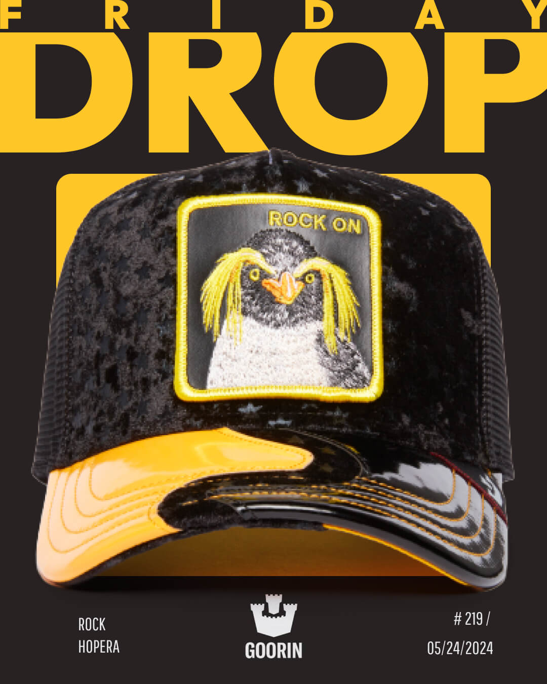 A black and yellow trucker hat with a patch featuring a yellow-crested penguin and the words ROCK ON is displayed against a black background with bold yellow text, showcasing one of our most bold hat designs.