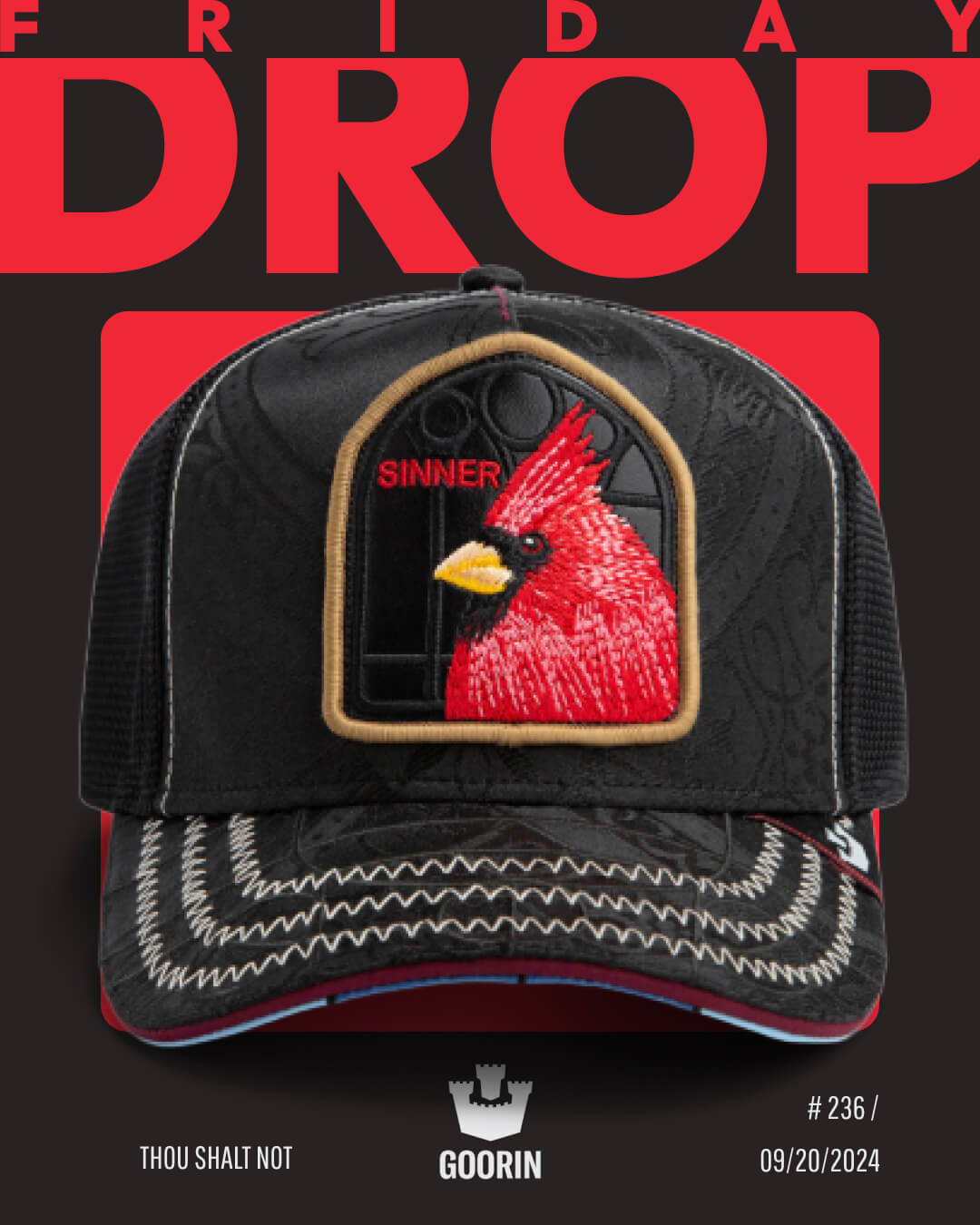 A Goorin black mesh trucker hat features a red cardinal patch labeled SINNER on the front, set against a striking black and red background with the text FRIDAY DROP—perfect for fans of bold hat designs.