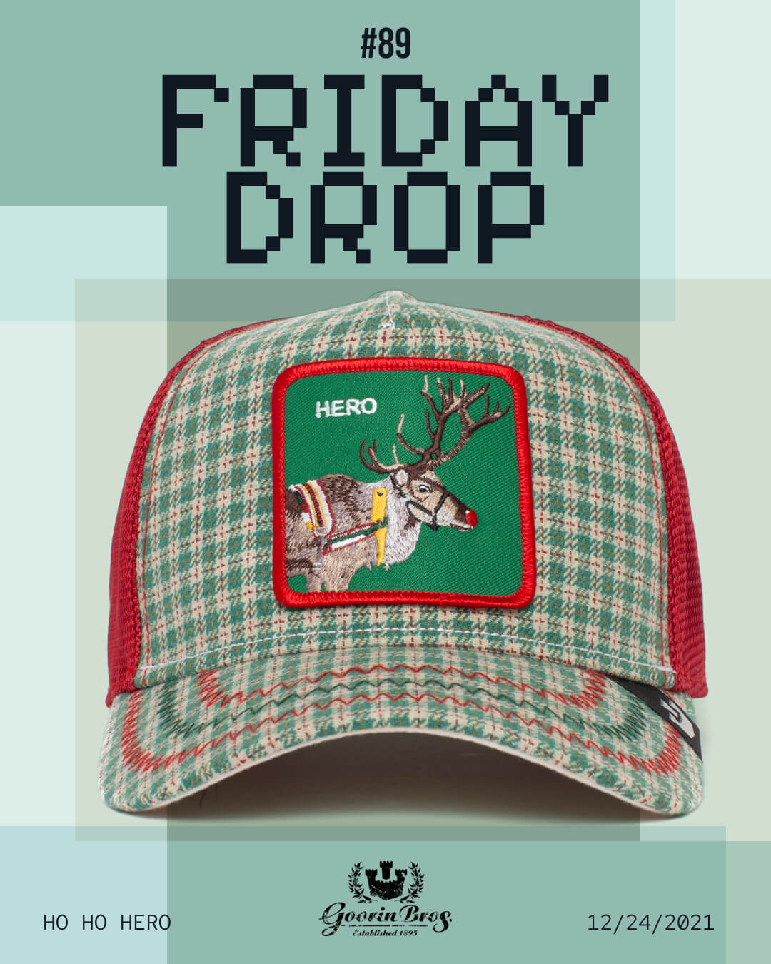 A green and red plaid trucker hat with a reindeer patch labeled HERO is displayed under the text #89 FRIDAY DROP. Showcasing Goorin's bold hat designs, the bottom mentions HO HO HERO and 12/24/2021.