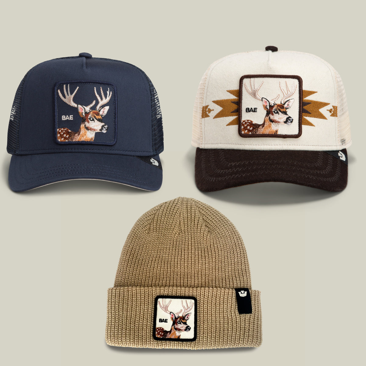 Three hats from the Goorin Bros. “The Only Bundle For Me Bundle” are displayed: two trucker caps with signature deer patches—one in navy and one in cream—sitting on top, and a tan knit beanie featuring the same deer patch below them, all arranged on a neutral background. This stylish hat bundle is perfect for any hat lover seeking versatile options for every occasion.