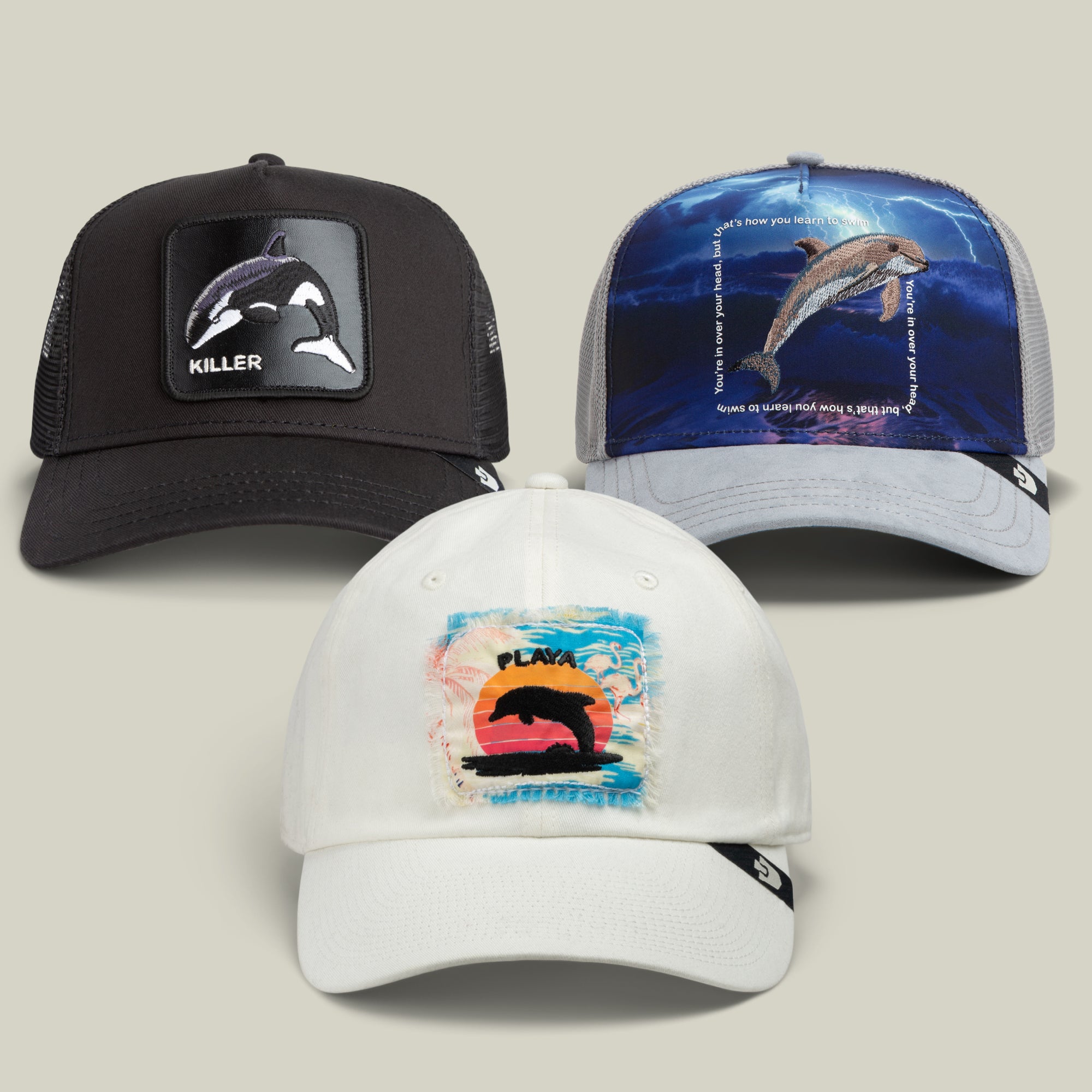 Make a splash with the Water World Bundle by Goorin Bros.: this trio features a black cap with an orca killer patch, a grey cap with a dolphin underwater graphic, and a white cap showing off a colorful sunset with an orca—an ocean-inspired collection that’s perfect together.