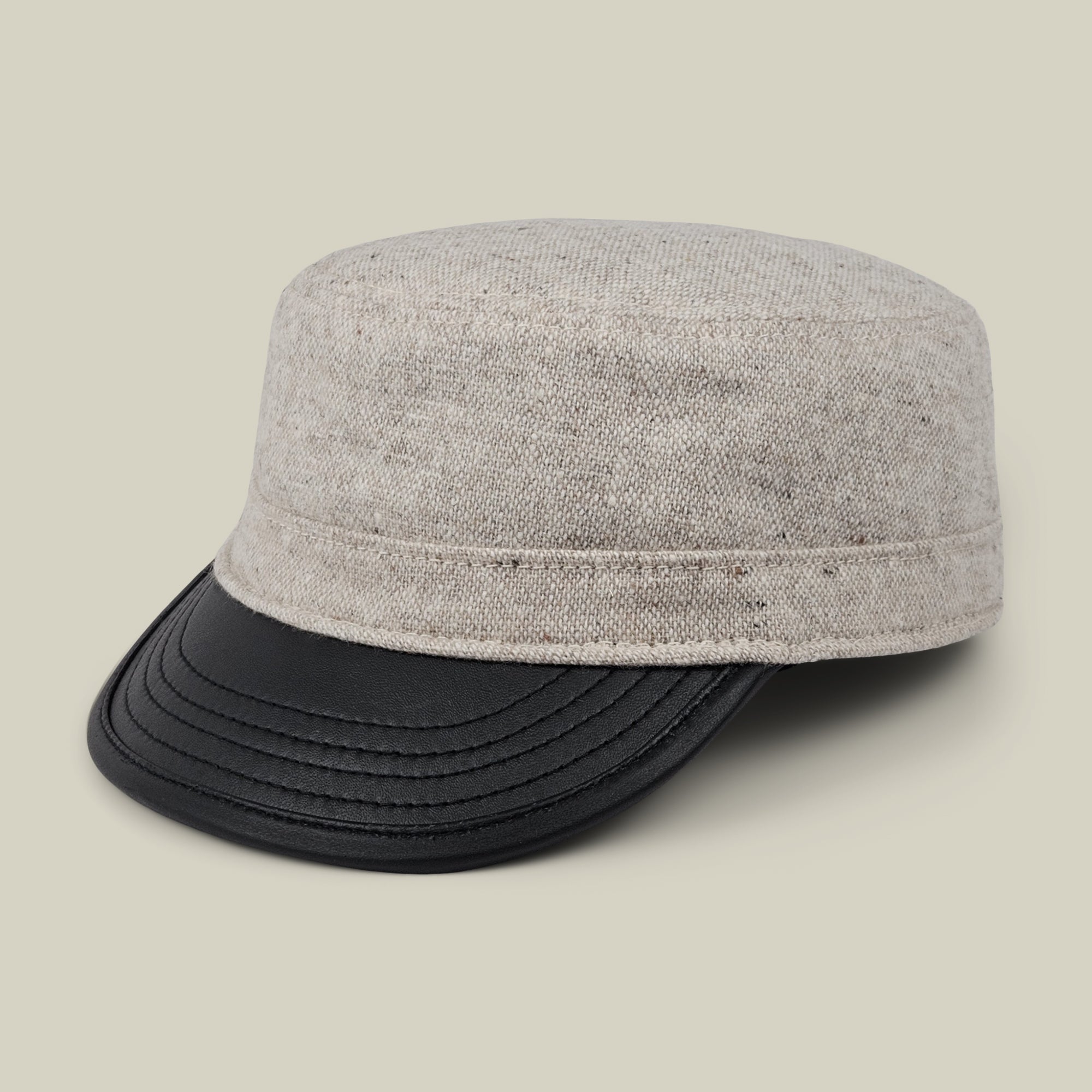 The Goorin Bros. South Boulder cap is a heritage-inspired gray fabric hat, hand cut and sewn in the USA, featuring a black faux leather brim and shown against a plain light background.