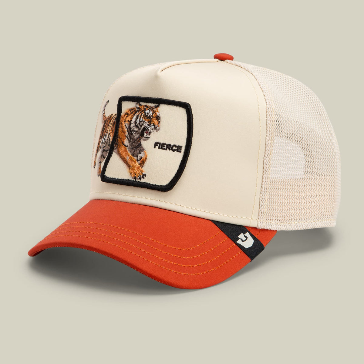 The Goorin Bros. Migration - Fierce trucker hat features a cream and red colorway with a mesh back panel and an embroidered tiger patch with black border and "FIERCE" text on the front.
