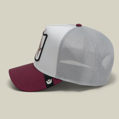 The Goorin Bros. Migration - Oops trucker hat features a white front panel with black embroidered design, maroon bill, and gray mesh back with snapback closure, shown in a studio side view.